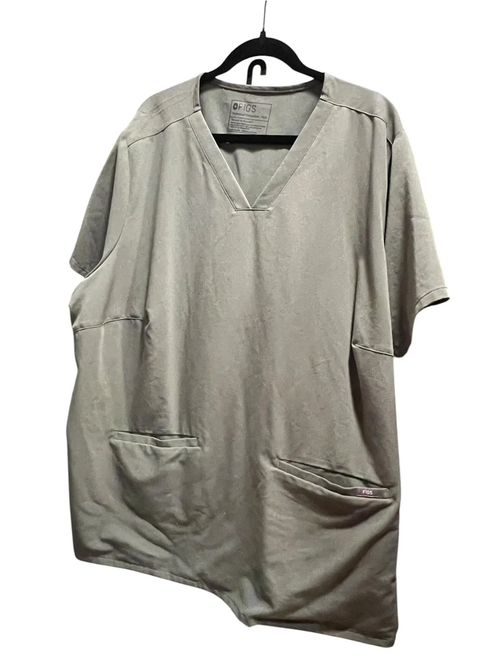 FIGS Casma three-pocket V-neck scrub top featuring a soft greyish-green.
